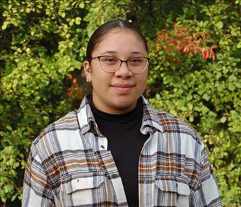 Photo of Office Manager, Paola Morales standing outside